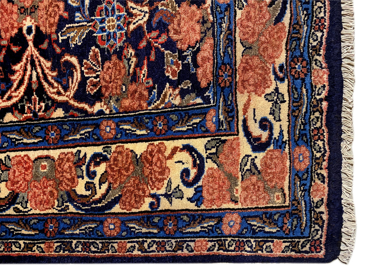 Teppich-Ecke mit Fransen und blau-rotem Ornamentmuster, sichtbarer Randabschluss
