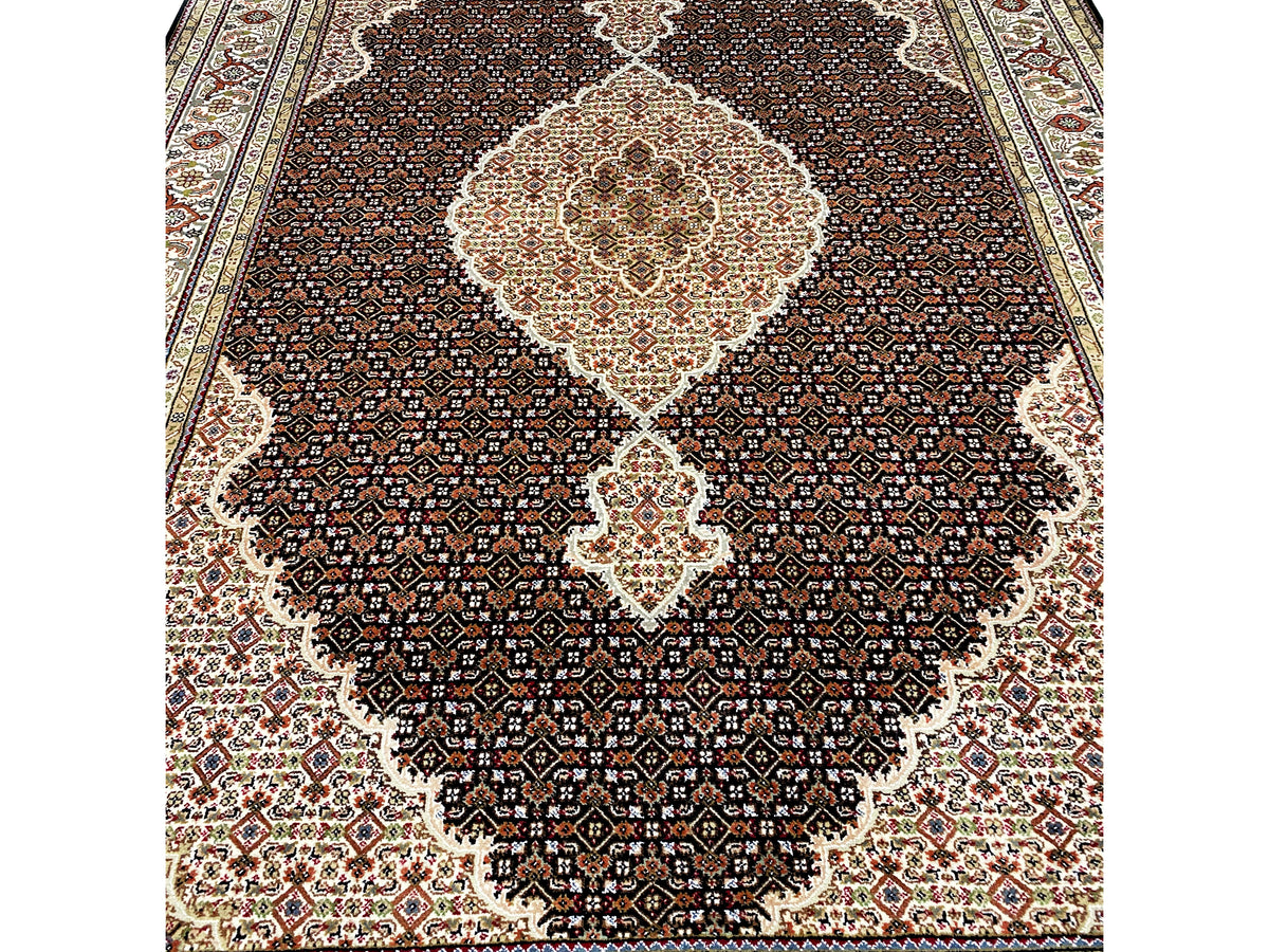 Brauner Indo-Tabriz Teppich Detail: feines Muster im dunklen Feld mit hellem Zentrum