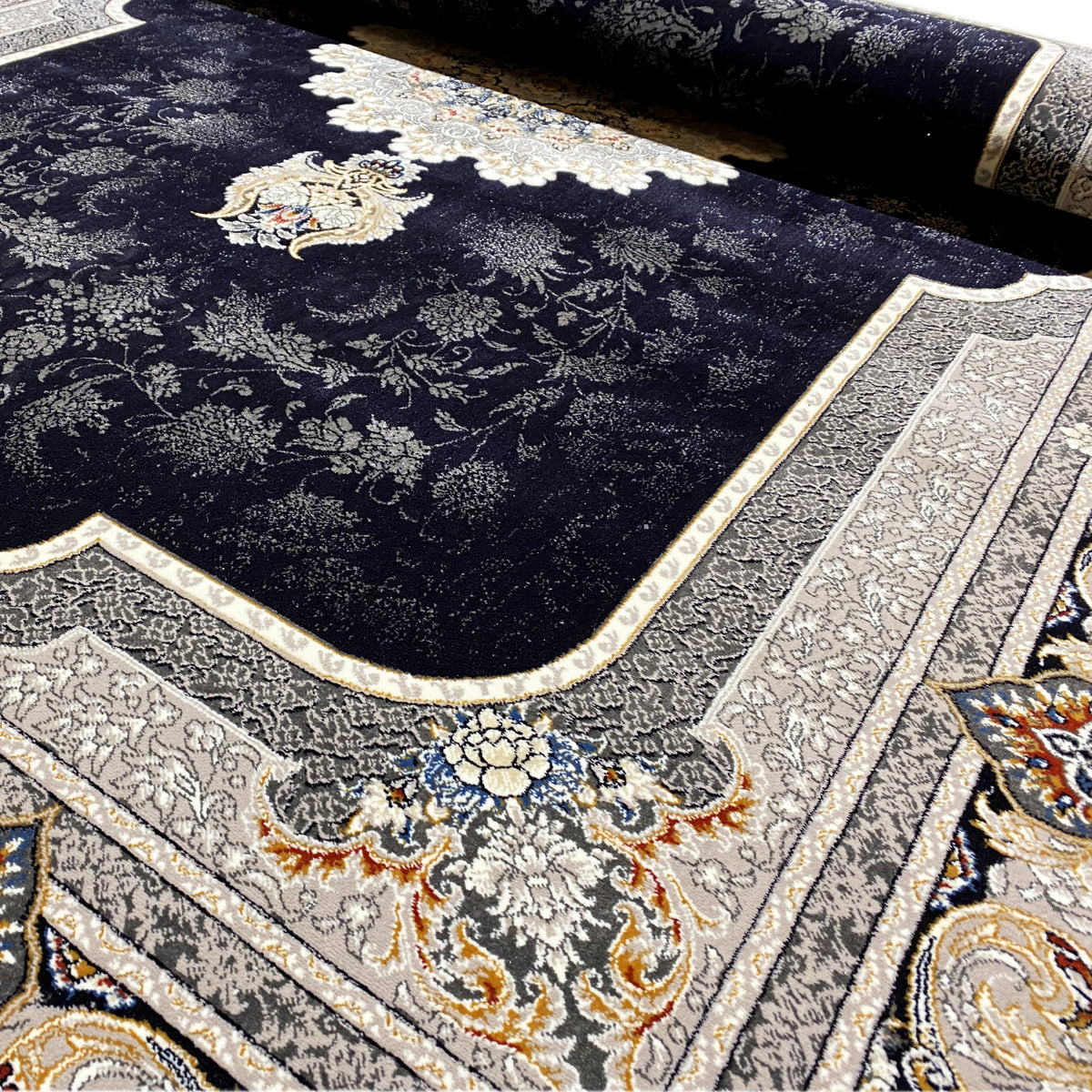 Teppich-Detail mit dunklem Flor und feinen Ranken im Muster, creme Umrandung und Bordüre