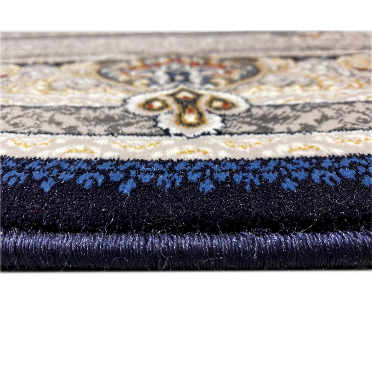 Teppichrand im Detail: Fransen oben, dunkler Flor und blaues Ornamentband
