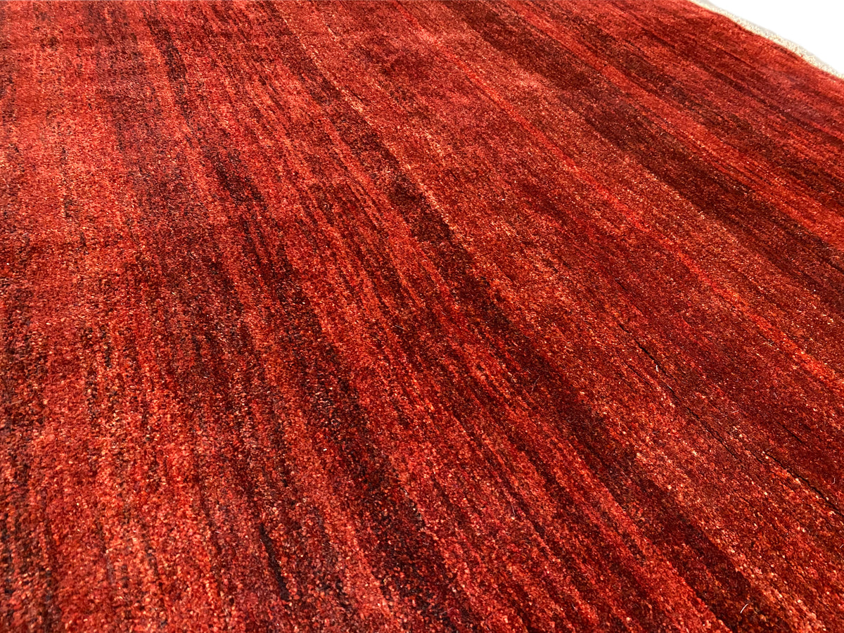 Rote Teppichoberfläche mit dichter, melierter Schlingenstruktur, detailreicher Flor